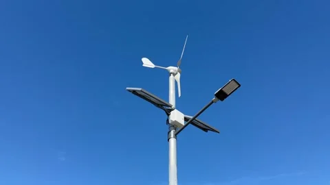 Implementing street lamps that use solar and wind energy can significantly Stock Footage 316834854