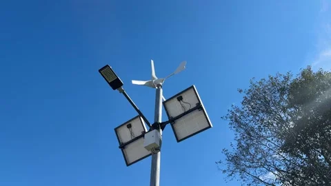 Implementing street lamps that use solar and wind energy can significantly Stock Footage 316834880