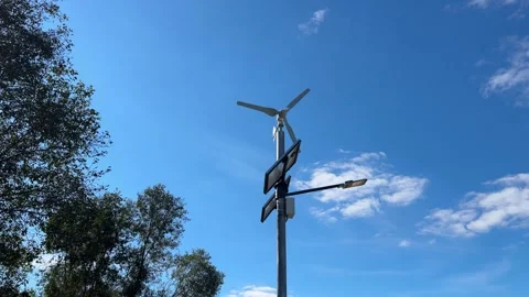 Implementing street lamps that use solar and wind energy can significantly Stock Footage 316834981