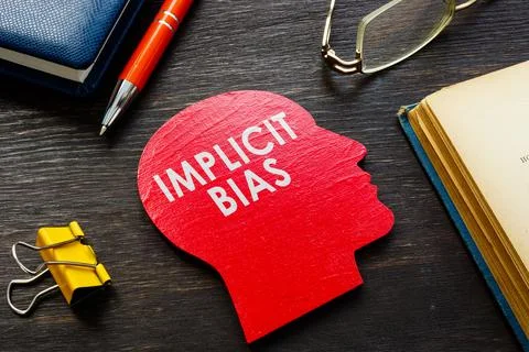 Implicit bias word on the head shape on the desk. Foto stock