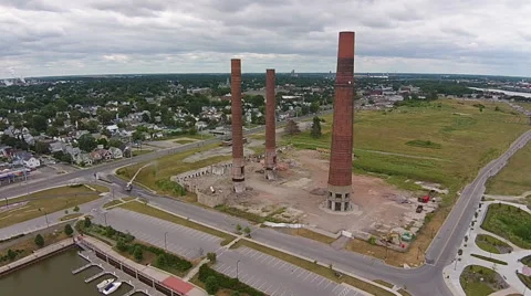 Implosion of two smoke stacks, demolition seen from the air Stock Footage 49725647