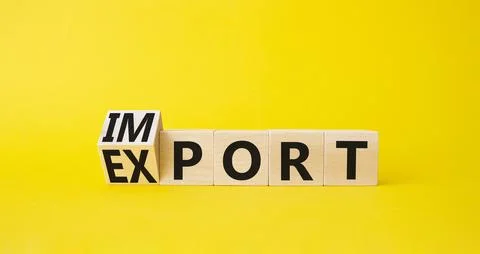Import and Export symbol. Turned wooden cubes with words Export and Import. B Stock Photos
