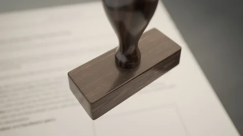 An important document being denied by red office stamp in slow motion. 4KHD Stock Footage 119981474