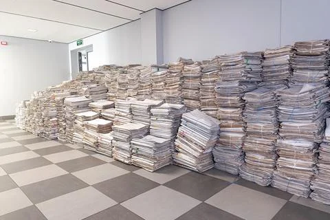 Important documents piled for relocation in modern office space during moving Stock Photos