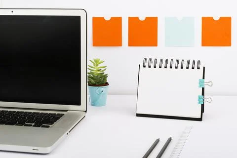 Important Messages On Notebook And Lap Top On Desk With Notes, Pencil And Flower Stock Photos