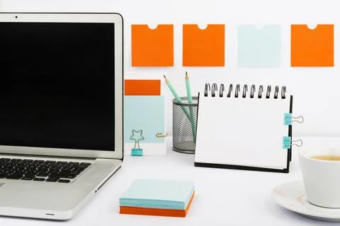 Important Messages On Notebook And Lap Top On Desk With Notes, Pencil And Cup Of Stock Photos