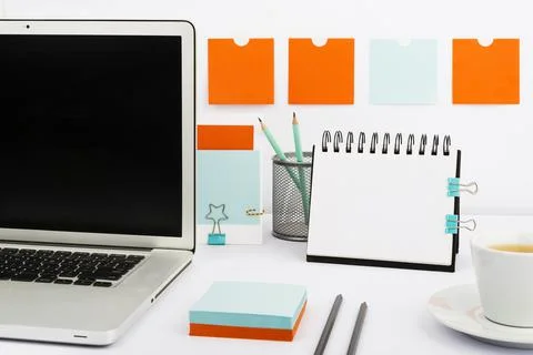Important Messages On Notebook And Lap Top On Desk With Notes, Pencil And Cup Of Stock Photos