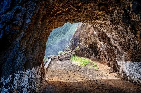 Imposing cave in the rugged mountainscape 写真素材
