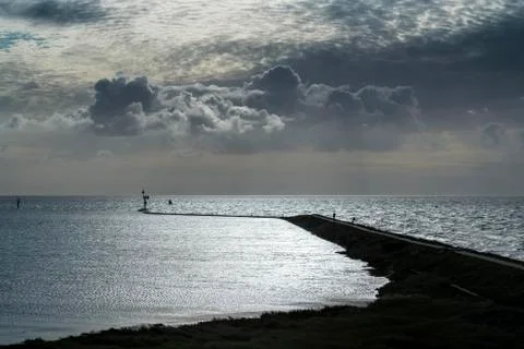 Imposing cloud formations above the pier of West Terschelling . Stock Photos