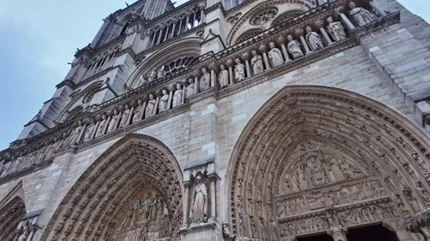 Imposing facade details of the gothic Notre Dame cathedral with intricate Stock Footage 303414096
