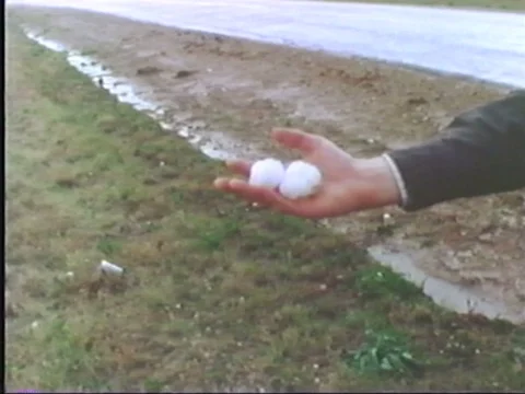 An imposing tornado twists across rural American countryside in the 1970s. Video stock 75188160