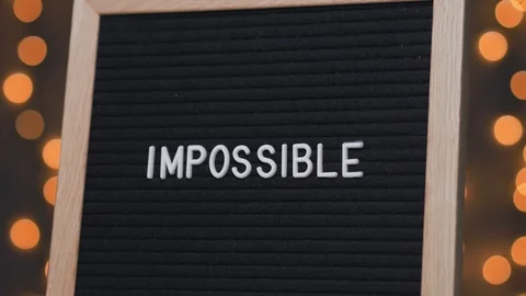 IMPOSSIBLE Transformed in POSSIBLE on a Letterboard Stock Footage 105087445