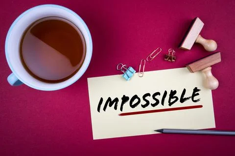 Impossible. Word possible underlined with a red stripe. Teacup, pencil and Stock Photos
