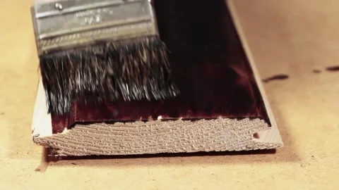 Impregnation of the board with a protective solution. DIY Stock Footage 158392562