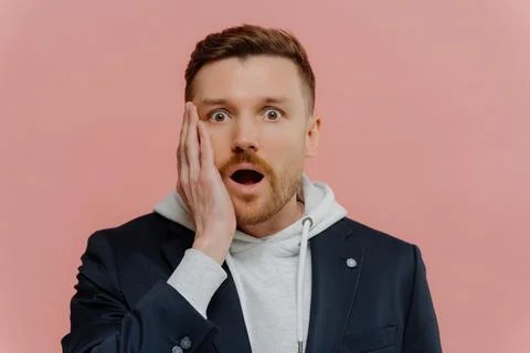 Impressed guy getting some awesome news and being in shock Stock Photos