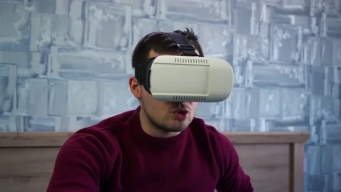 Impressed man after putting on VR glasses for the first time Stock Footage 149690507