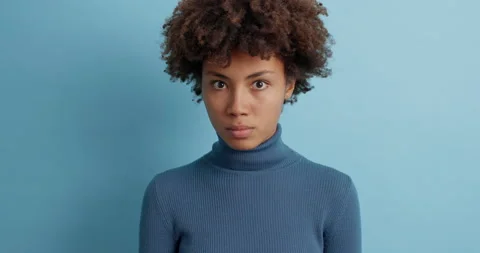 Impressed puzzled dark skinned Afro American woman with curly hair keeps mouth Stock Footage 143625897