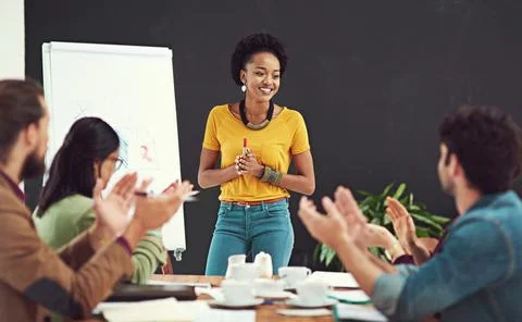 Impressing and inspiring her team. Cropped shot of people applauding together in Stock Photos