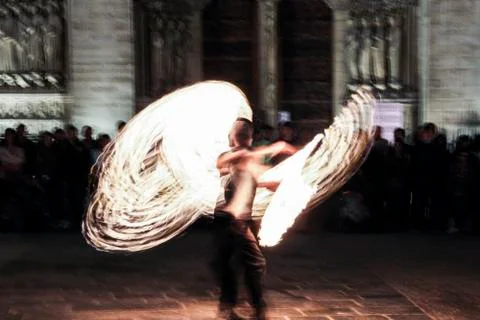 Impression: fire juggler performing in front of the night crowd in Paris, Fra Photos