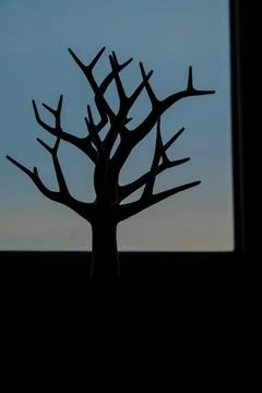 Impressive 3D printed tree silhouette stands tall against a twilight sky Stock Photos