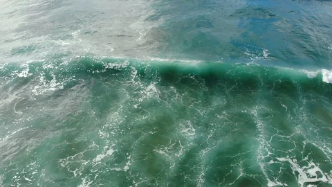Impressive aerial view of splashing waves motion over gradient blue sea water,4k Stock Footage 120031512