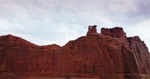Impressive big rock with rounded tops. Rising high up to the top and cloudy Stock Footage 212137286