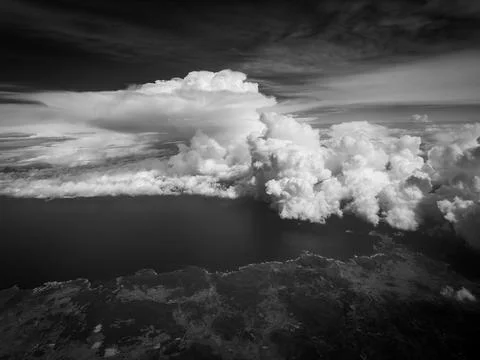 Impressive clouds can be seen in the sky during the flight Stock Photos