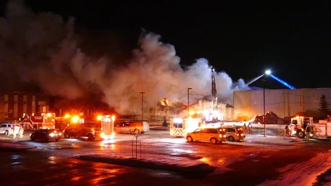 Impressive but devastating shot of large fire in industrial building at night Video stock 101815608