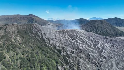 An impressive drone shot captures the rugged slopes of an active volcano with Stock Photos