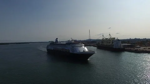 Impressive drone shot in flight crossing path of navigating cruise ship - 24fps Video stock 104108260