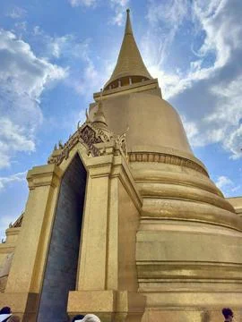 Impressive low-angle view of the massive glittering golden Phra Siratana Stock Photos