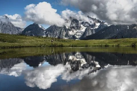 Impressive mountain range reflected in a clear lake with clouds, Georgia, Stock Photos