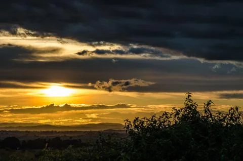 Impressive sunset with storm clouds towering in distance in northern Angola Stock Photos