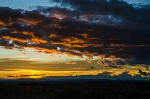 Impressive sunset with storm clouds towering in distance in northern Angola Stock Photos