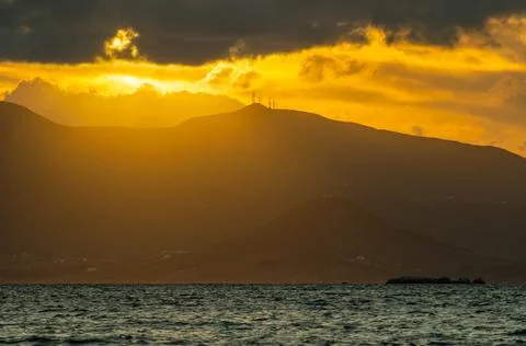 An impressive sunset with the wide view over the sea at a mountain at the Naxos Stock Photos
