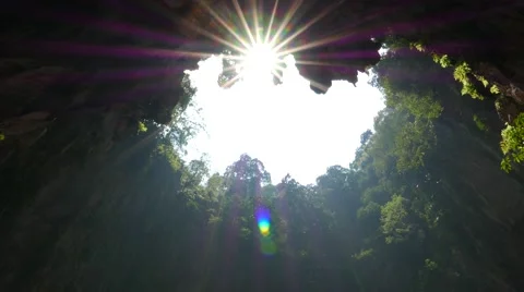 Impressive sunshine through open cave ceiling, blazing sunstar Stock Footage 50565435