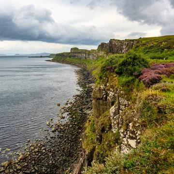Impressive vertical-walled cliffs on the Scottish island of Skye, UK. Stock Photos