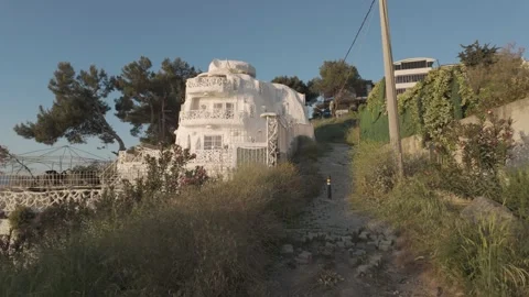 Impressive view of a large white house on beach at beautiful sunset Stock Footage 311113390