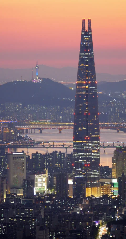 Impressive view of Lotte World Tower against city and colorful sunset afterglow Stock Footage 295056755