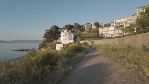 Impressive view from a lower angle of a large house on beach at beautiful sunset Stock Footage 311113355