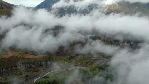 Impressive view of steep rocky mountains through clouds and fog. Stock Footage 237767168