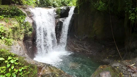 Impressive waterfalls emerge deep in the jungle, surrounded by mountains Stock Footage 343890995