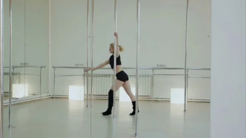 Improbable pole dancer makes a split while hangs upside down on a pylon in the Vídeos de archivo 76416084