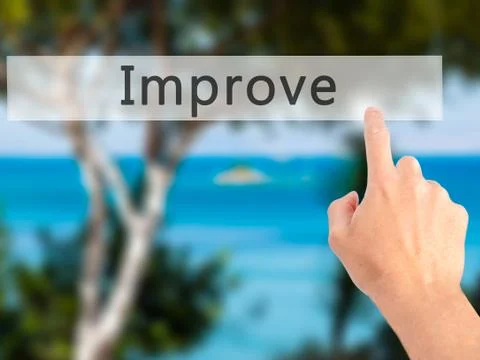 Improve - Hand pressing a button on blurred background concept . Business, te Stock-Fotos