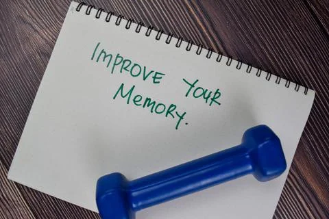 Improve Your Memory write on a book isolated on Wooden Table. Stockfoto's