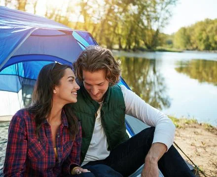 Improve your relationship by going camping. an adventurous couple out camping Stock Photos
