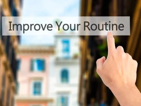 Improve Your Routine - Hand pressing a button on blurred background concept . Stock Photos