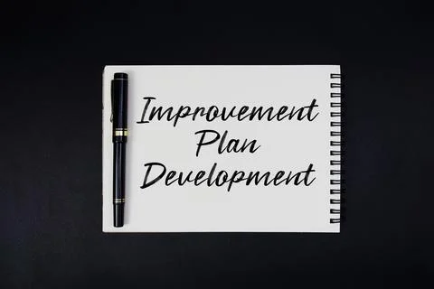 Improvement Plan Development text written on notepad Stock Photos