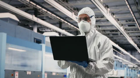 Improving integrated circuits design, laptop and scientist in microchip factory Stock Footage 333394728