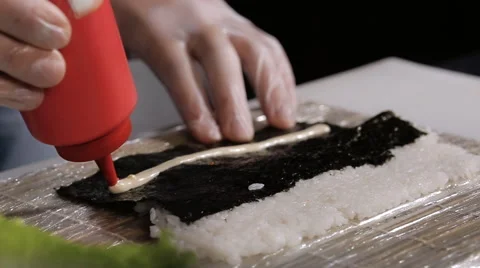 Improvisation sushi Rolls in the studio. applying sauce and unfolding pieces of Stock Footage 59356686